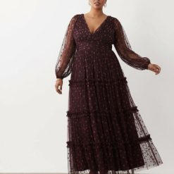 robes à pois transparentes longue en tulle manches ballon roses couleur prune avec col en v et jupe a etages portee par un mannequin grandes tailles