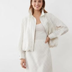 vestes à pois ensemble jupe et veste ivoire col montant manches longues motif petits pois noirs