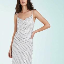 robes mousseline à pois bretelles fines col bénitier blanc neige portée par un mannequin sur fond clair avec une coupe fluide et élégante