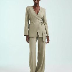 blazers à pois olive encolure ronde avec lin mélangé porté par une femme avec un pantalon assorti