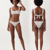 brassières à pois avec bikini blanc maillot de bain femme deux pièces imprimé à pois noirs avec un anneau doré au centre du haut de maillot
