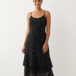 robes à pois noirs et blancs bretelles longue fines a volants mi longue pour femme sur fond blanc