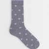 chaussettes à pois design style gris et lilas en maille côtelée avec bordure violette claire sur fond neutre