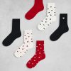 chaussettes à pois multicolore lot de 7 paires et cœurs disposées sur fond gris aux motifs de cœurs rouges noirs et blancs