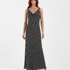 robes évasées à pois bénitier col longue manches sans noir anna dot élégante robe longue sans manches noire à pois blancs idéale pour lété