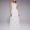 robes à pois transparentes bandeau plissée longue exclusivité petite blanc portée par un mannequin sur fond gris avec des sandales noires
