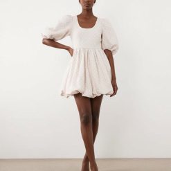robes à pois jaune bouffantes manches courte ourlet boule rose portée par un mannequin femme de face sur fond neutre