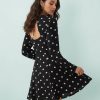 robes évasées à pois noirs courte découpe dos ourlet avec manches longues et motif imprimé porté par une femme