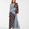robes à pois années 50 bénitier foulard longue détail col bleu robe longue à motifs pois de différentes tailles et couleurs portée par une femme aux cheveux roux devant un fond blanc