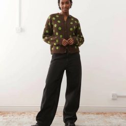 cardigans à pois et imprimé carrée coupe brown porté par une femme aux cheveux bouclés avec des pois vert pomme