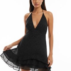 robes asymétriques à pois volants ourlet longue dos nu élégante robe noire à pois fins et volants asymétriques portée par une femme