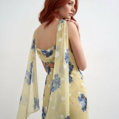 robes à pois jaune longue jacquard dos ouvert vert bleu fleuri portée par un mannequin aux cheveux roux avec des voiles fluides aux épaules