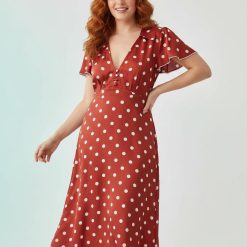 robes à pois rouge évasés col v et mancherons portée par une femme aux cheveux roux