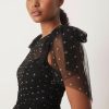 robes longues à pois rouge noirs tulle en nœud avec épaules étagée portée par une femme avec du tissu transparent noir et des pois dorés