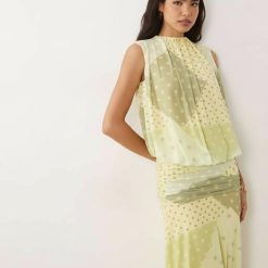 robes en tulle à pois froncée taille basse jupe blousante longue jaune et verte sans manches portée par un mannequin sur fond blanc