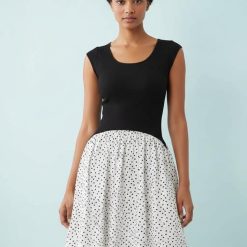 robes roses à pois blanc longue hybride encolure dégagée sans manches avec un haut noir ajusté et une jupe évasée blanche à pois noirs