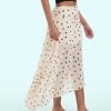 jupes à pois ivoire fente sur côté asymétrique longue en voile léger imprimée avec des motifs de petits points noirs